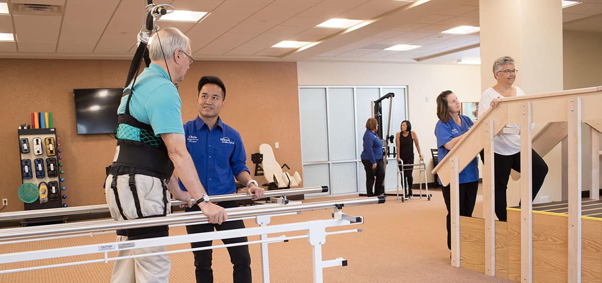 image of man helping with physical therapy for Family of Services Hillcrest Health Services